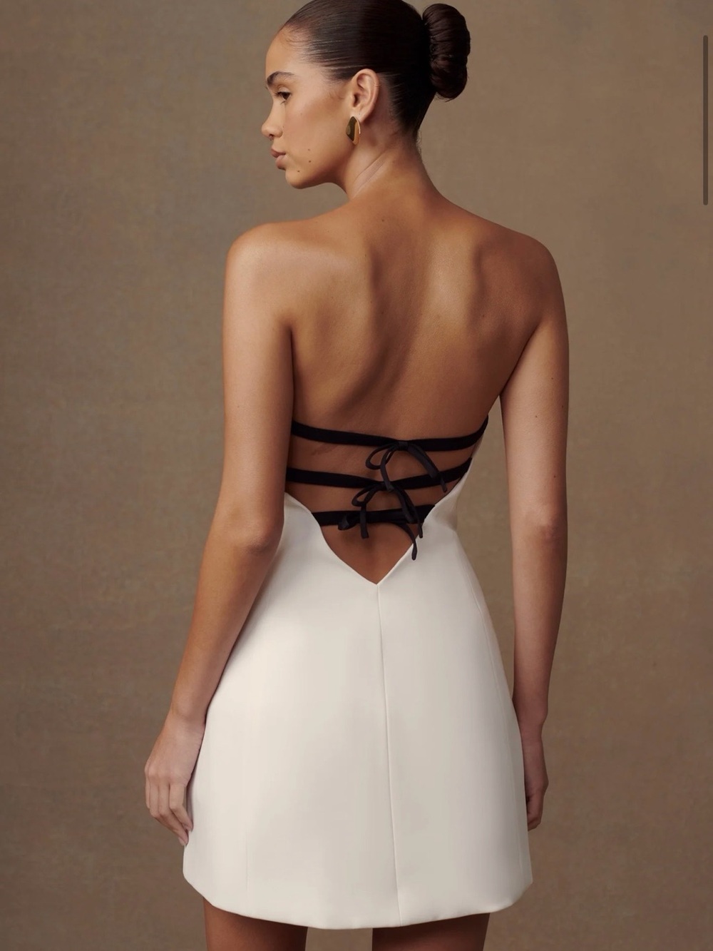 MESHKI White Backless Strapless Mini Dress with Black Lace-Up Straps.